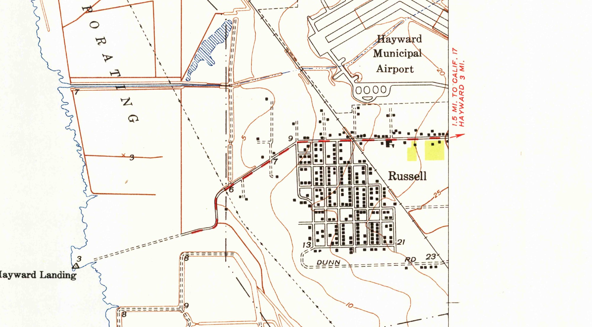 A detail of a United States Geological Survey topographic map. A dense grid of streets is labelled Russell, west of the Hayward Municipal Airport and east of Hayward Landing on San Francisco Bay. Every building in the grid is drawn as a small solid black square; there are several hundred of them. Dunn Road runs along the southern edge.