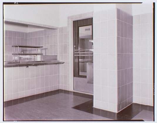 Interior architectural photograph showing an empty corner of the Federal Reserve Building's cafeteria.
